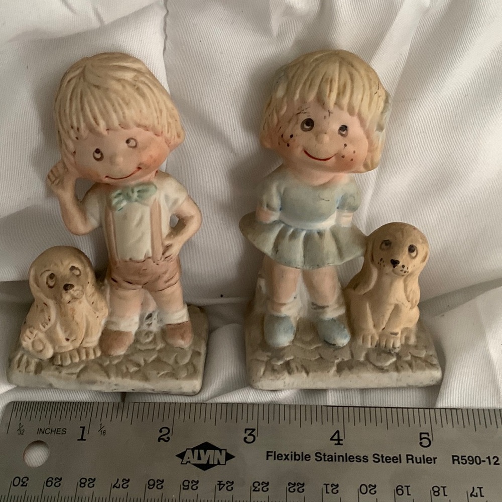 Small boy and girl figure with dogs